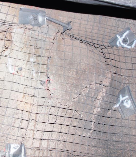 The mesh may be either external to or embedded within the shotcrete in order to dissipate additional energy demand and minimise material ejection during sudden loading events.