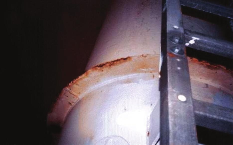 FIGURE 1-2 Galvanic Corrosion between Coated Carbon Steel and Stainless Steel Ladder the head and plate of bolted or riveted plates and between the overlapping areas of unsealed plates.