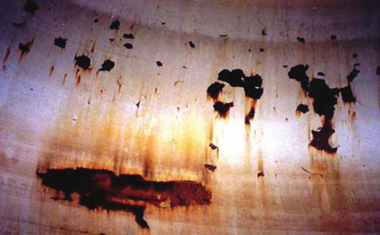 FIGURE 1-4 Corrosion at Coating Holidays Coating Pinhole Corrosion When the internal tank surfaces are coated with a dielectric material (e.g., epoxy), the corrosion activity will be concentrated at the holidays (holes) in the coating.