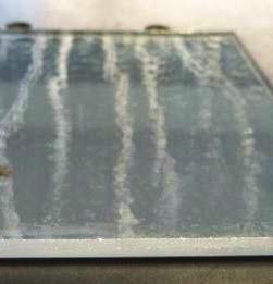 A top view on the glass surface from which the paint layers delaminated revealed the presence of
