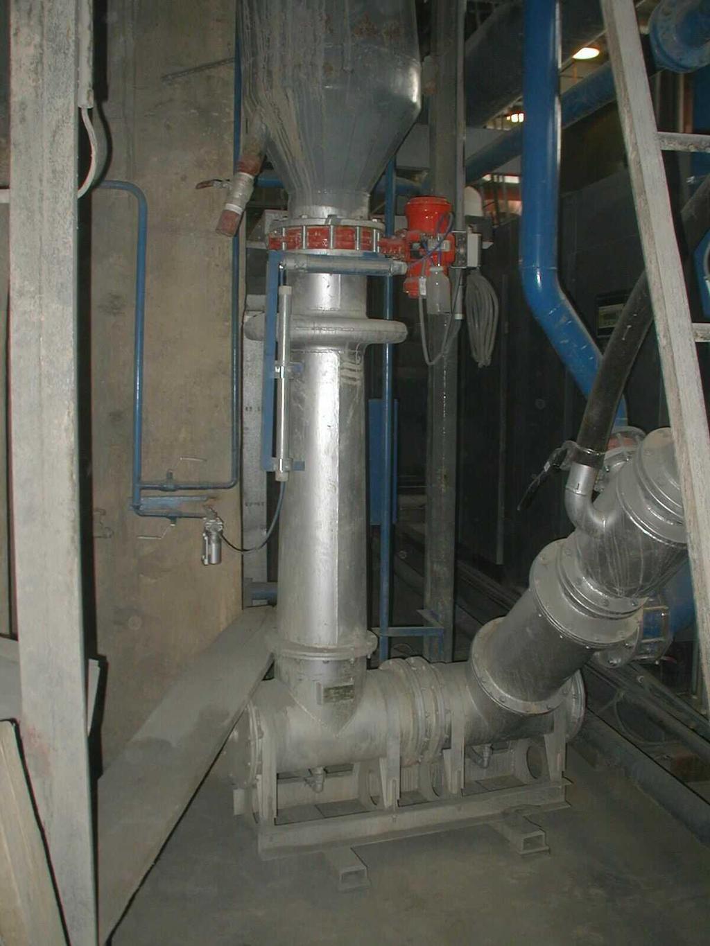 The fly ash output from hopers rotary feeders direct into conveying pipelines of low-pressure system and was conveyed through an immediate bin into a storage silo by a chamber feeder.