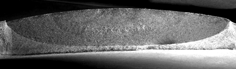 Next the blade was statically tensioned and ruptured with use the testing machine. Fig. 6 is a magnified view of the fractured surface.