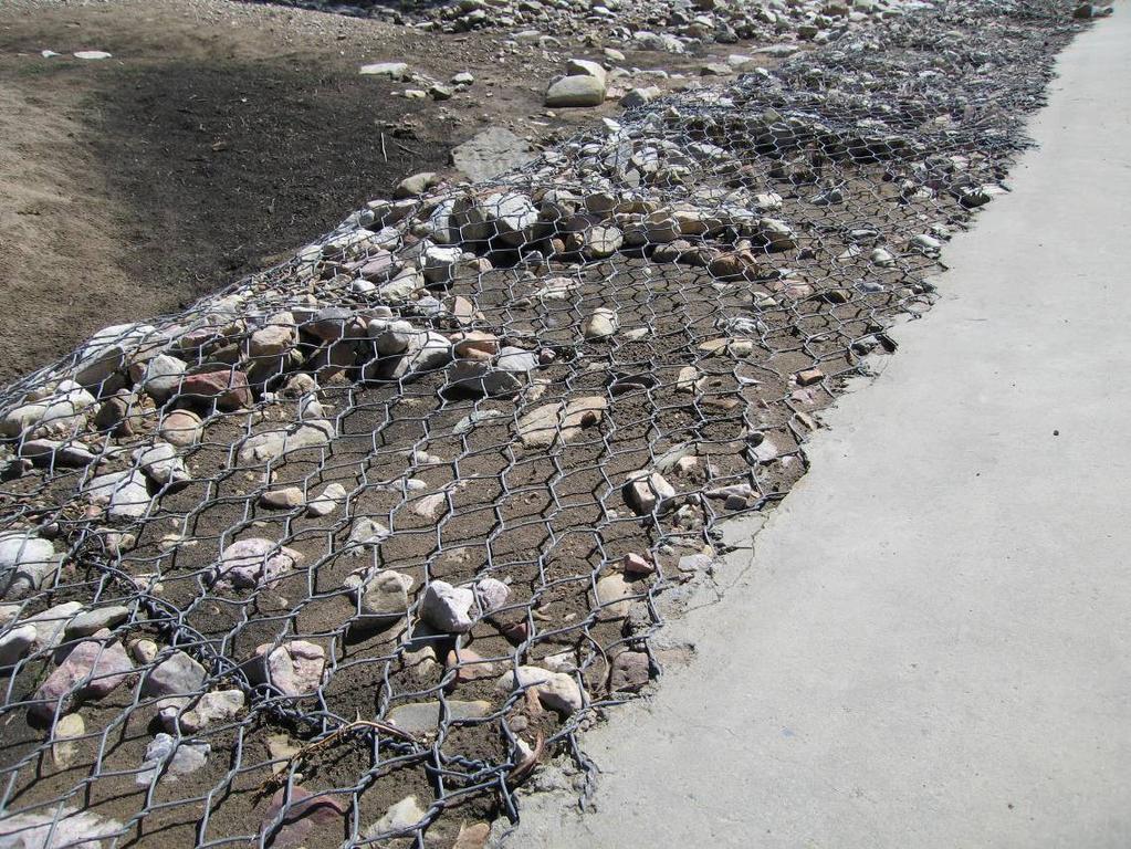 (i) Where gabion mattresses are laid on a slope and the top edges are to be fixed to a concrete element e.g. slope protection for a low level river structure, a detail will have been provided on the drawings for the manner in which the mattresses are to be fixed to the concrete element.