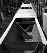 Twenty-one tests were conducted on a rectangular girder and four on a trapezoidal girder. The rectangular girder tests used an X-brace horizontal truss system as seen in Figure 3.1.
