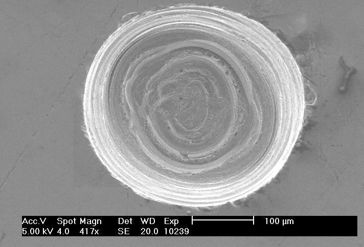 the machined surface of silicon as shown in Figure 4.14. These marks were mostly present along the periphery of the hole in a concentric fashion.
