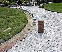 Start pulling the marked pavers up and take them to the table saw.