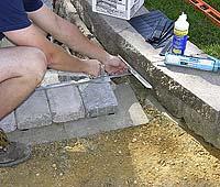 12 After the paver is cut, it is glued in place with a special masonry adhesive called superwet type
