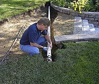 Since there may be a need to run a utility (electricity, sprinkler line, etc) to or from the house, a pvc sleeve was run under the base material.