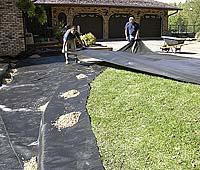 After the soil has been compacted, now is the time to install a woven geotextile fabric if required.