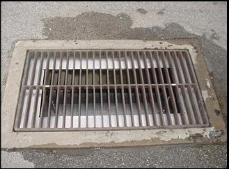 Where the Storm Drain Grate Rests Carefully Lower