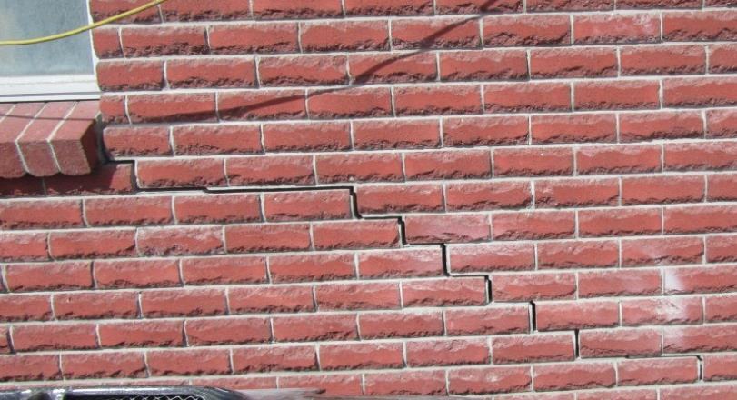 cracks, separations along cold joints, and displacement various building components relative to the brick masonry. Fig.