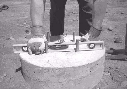 28. Verify that the top of the concrete is level (see Figure 2 13). Figure 2 13: Verifying the Foundation Is Level 29.