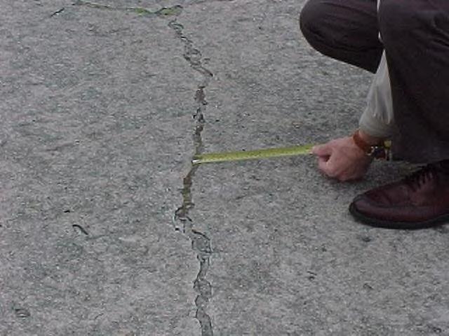 Then determine the number of slabs that have unsealed cracks wider than 1/8 inch.
