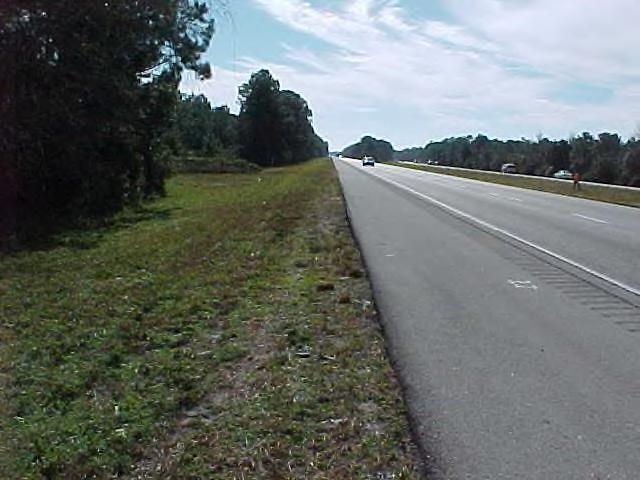 a paved shoulder, the first two feet adjacent to the paved shoulder