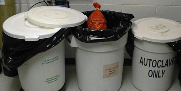 Figure 12.2 (Left) Labeled red container with lid for accumulating biohazardous waste (other than regulated sharps). (Center) Biohazard bag outside of a hard-walled container, which is unacceptable.