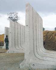 These walls cantilever loads (like a beam) to a large, structural footing, converting horizontal pressures from behind the wall to vertical pressures on the ground below.