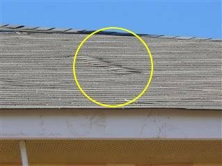 SUMMARY Photo 17 Roof System 11) - One or more roof trusses or engineered joists or rafters were improperly nailed. The roof decking is buckling or lifting as a result.
