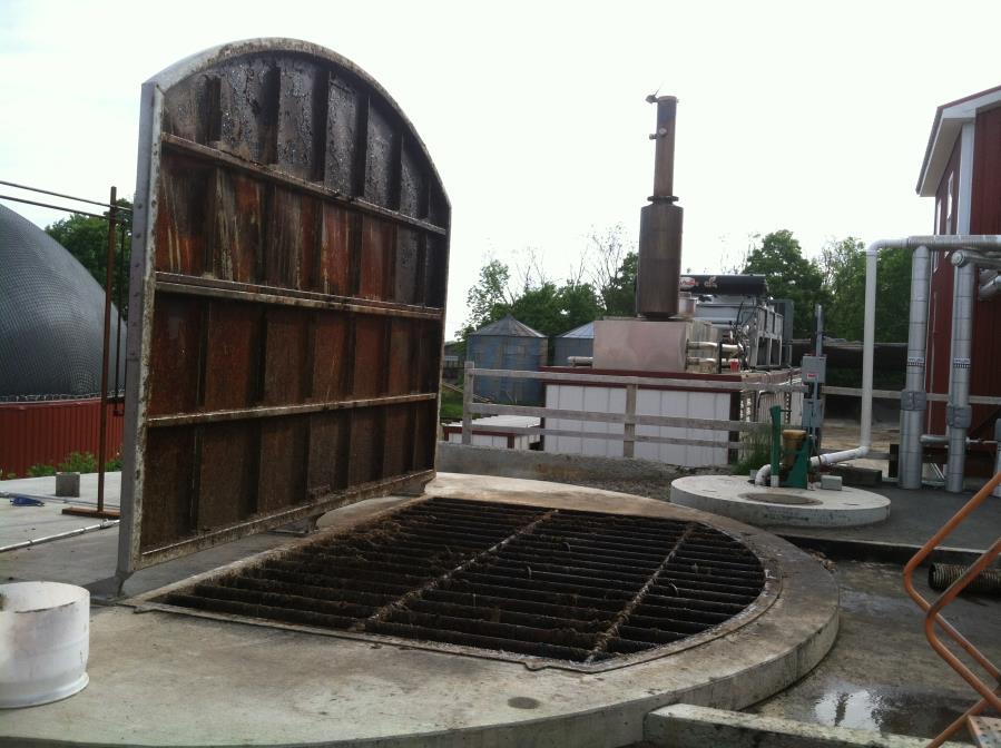4 store waste and rendering waste from pork producers. The food processing waste is received and stored in two 26,000- gallon designated food waste cylindrical concrete pits (Figure 2).