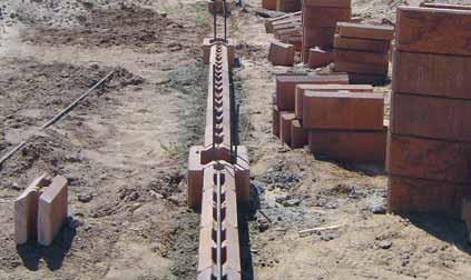 Excavate the pile holes to the depth and diameter specified in the approved construction design. When drilling the holes keep in mind that hole positioning is critical.