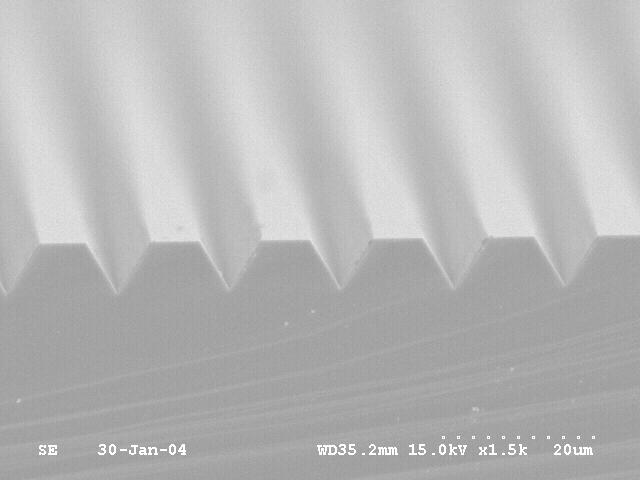 Figure 5.12 is an SEM picture of the acute angle groove stamp with 9 µm gaps and 11 µm spacing. Figure 5.