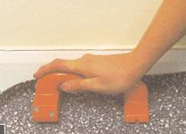 Areas that cannot be rolled with the large roller e.g. abutments such as door frames or skirting boards should be rolled with a hand roller or pressed into the adhesive with a rubbing board.