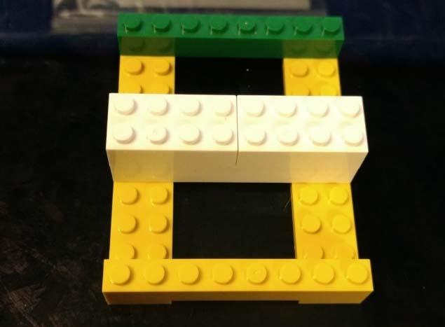 Then place another Brick 1x8 piece on the fourth peg of the Plate 2x10 pieces. 3.