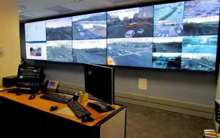 Personnel electronically monitor traffic conditions using closed-circuit television and vehicle sensors.