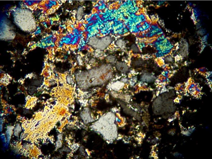 Thin Section Showing Poikilotopic Anhydrite Cement at 1492 ft. Poikilotopic means one large crystal that engulfs many small grains.