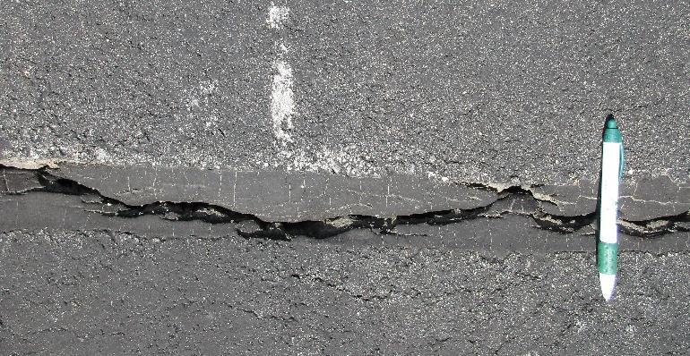 Causes: Poorly constructed paving lane joint, shrinkage of the surface due to