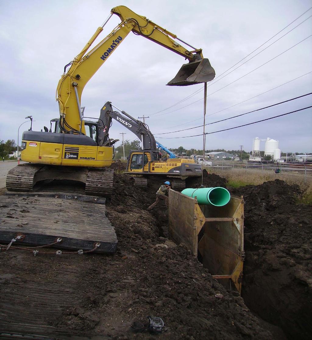 Redraw the insertion line on the spigot using a factory-marked spigot as a guide. Place the pipe and fittings into the trench using ropes and skids, slings on the backhoe bucket, or by hand.