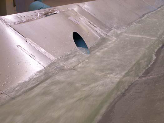 Scaled model of supercritical channel with lateral outflow Different pipe diameters were tested with 30, 45, and 90 angles to the downstream flow.