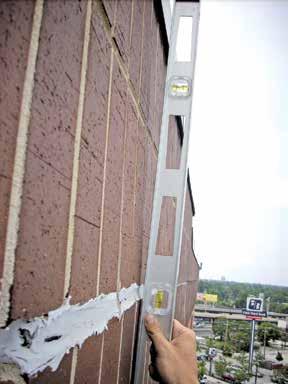 The estimated vertical expansion (moisture and thermal) of the brick masonry for the full height of the building was approximately 0.9 in.
