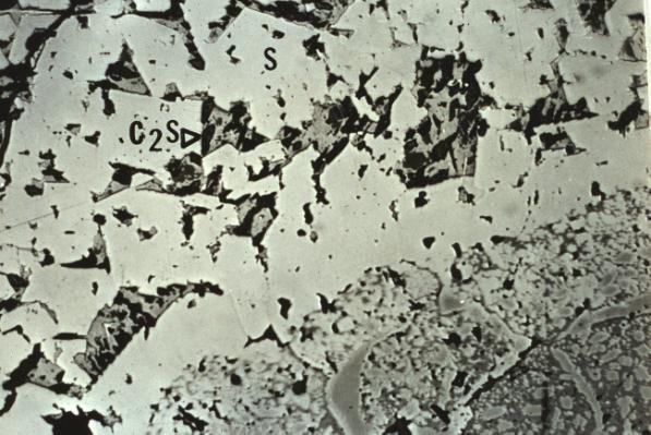 crystals appear to be eroded from the refractory surface in response to the extremely high temperatures and the intensity of the slag contact.