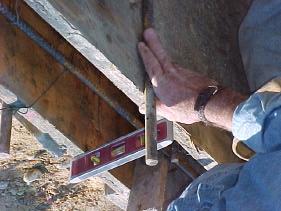 Using a form clip for a guide to install form stakes, drive stakes plumb at the outside of the form clip. Stakes go at 18 from each board end and one in the middle.