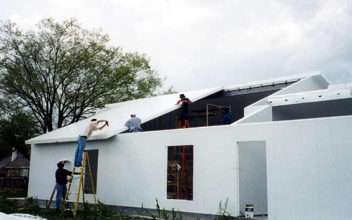 DAY 3: Successive roof panels are positioned, sealant