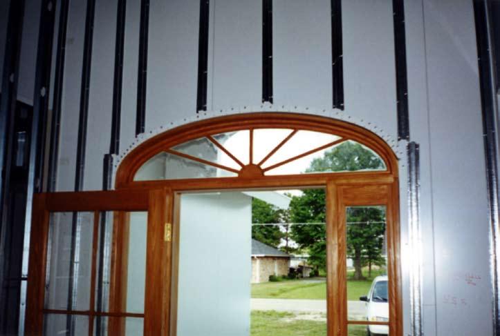 Prior to application of drywall, material inside of panel walls are furred out using 1 ½ hat