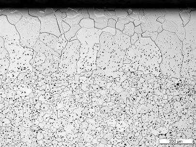 The surface shows an almost dense layer within a range of about 200 µm. Below this layer a typical material structure with sintering pores is visible, the residual porosity is about 5 %.
