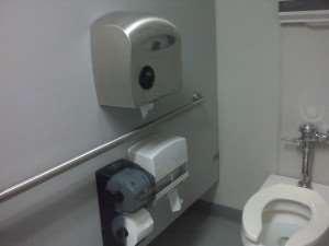 Dispensers can not protrude from wall above the grab bar.