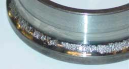 FIGURES Figure 1 An angular contact bearing (7210) that failed after 1900h running with a polyolester oil diluted with R-134a at a concentration of 26%.