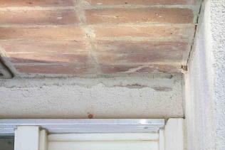A proper sealant joint or flashing should be installed to prevent water from draining between the house and the porch.