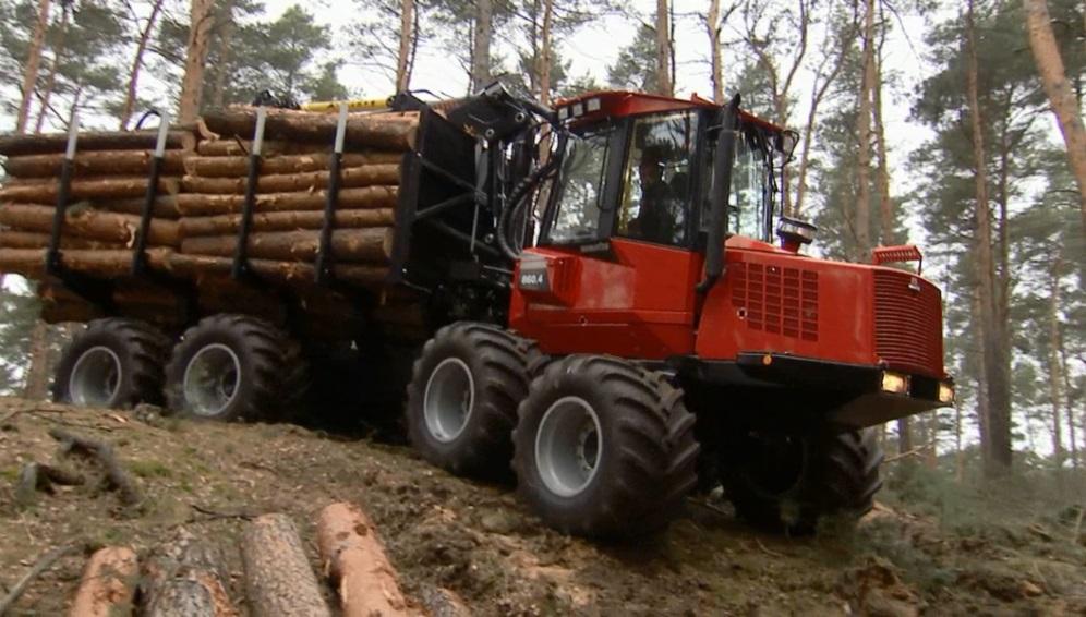 Forwarder Extracting logs after bucking tree from site to public roadside.
