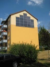 Energy-efficient retrofitting of an old housing block into the German standard of low energy houses 3 blocks - each 8 flats 40 years old heating system authority: B & O View of the block with PV -