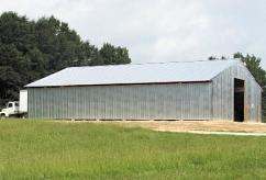 Deliver to markets or to a storage barn and protect bales from rain to prevent molding and nutrient leaching (Fig. 9). Figure 9. A barn is needed to protect and/or dry pine straw.