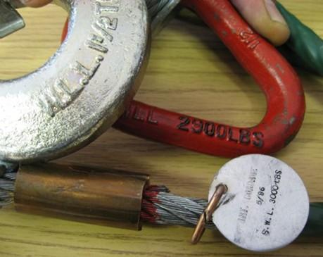 In example 1 (below), the pear link is marked with a limit of 2900 lbs, the leadline tag shows 3000 lbs, and the hook shows 1 ½ tons (3000 lbs.). In example 2, the leadline identification tag shows 3000 lbs.