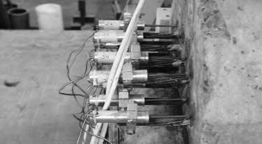 beam. The measurements were taken on each strand using a 2 in linear potentiometer that was attached to the strands using a bracket system as shown in Figure 10.17.