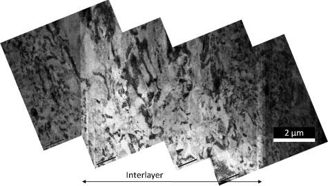 12 Stitched TEM image of weld interface including interlayer large platelet-like features. It is also a part of the transition into the bond zone, as shown in Fig. 5.