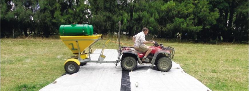 Fig.1 Maurice Gray pre-checks fertiliser application rates. Note the green water tanks fitted. Fig.