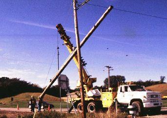 The pole must be hoisted into place, without damage, and plumbed or raked as directed by the Engineer.