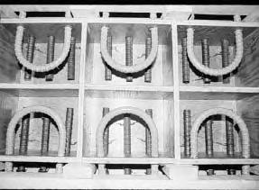 The front plywood panel of each compartment was predrilled to position the top and bottom bars at the proper dimensions.