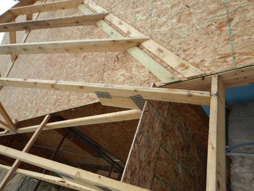 Raising Garage Trusses & Sheeting The Roof The objective of this section is to successfully raise/set the garage trusses, frame the lay-on to the house roof and to sheet the combined roof in
